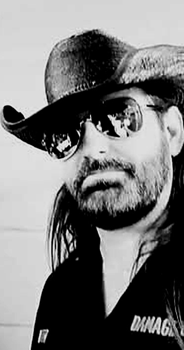 Jeff McKinney in a black cowboy hat and aviator sunglasses